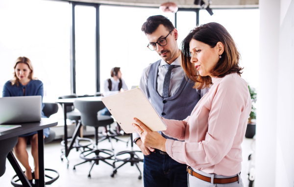 A group of young business people in an office, discussing issues when working.