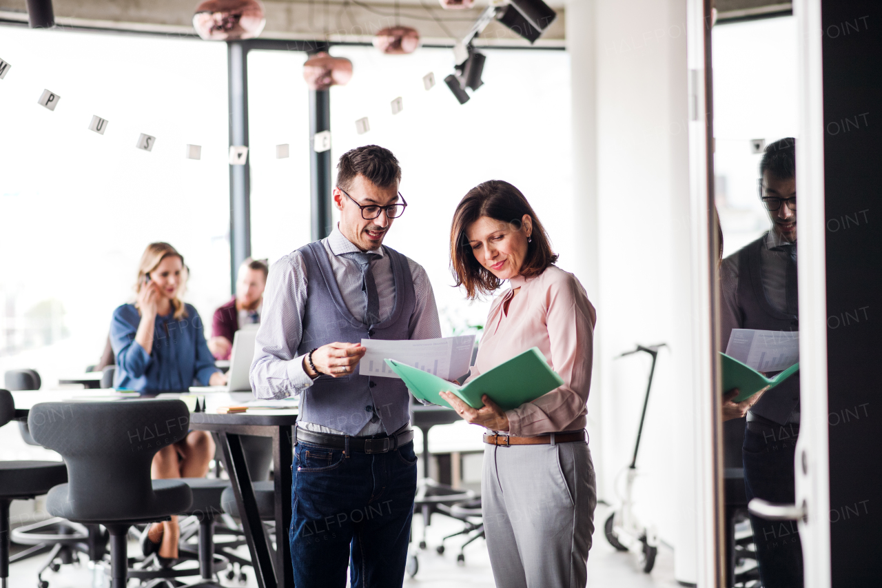 A group of young business people in an office, discussing issues when working.