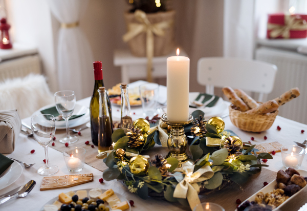 A decorated table set for dinner meal at Christmas time.