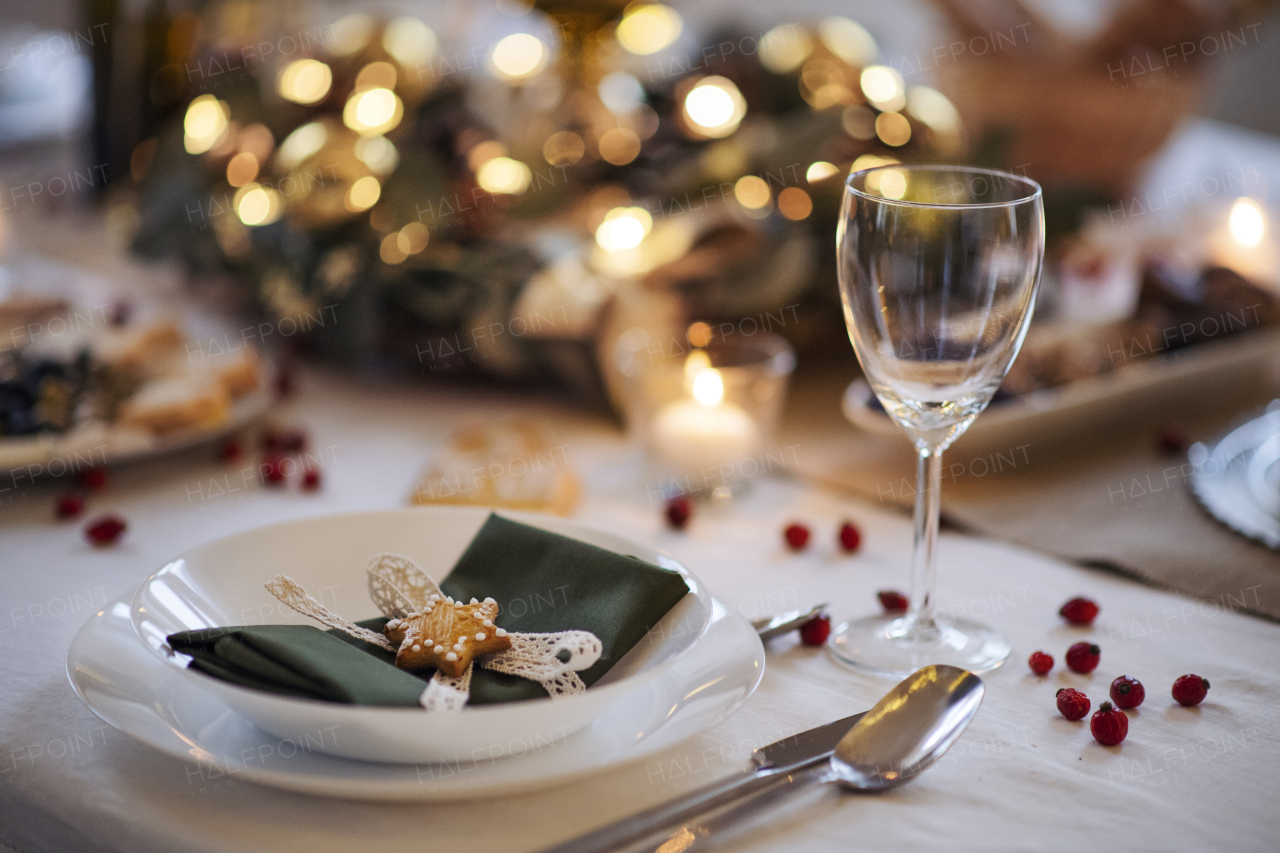 A close-up of decorated table set for dinner meal at Christmas time.