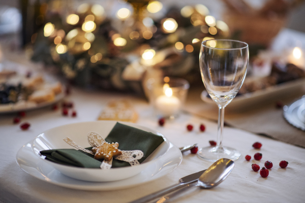 A close-up of decorated table set for dinner meal at Christmas time.