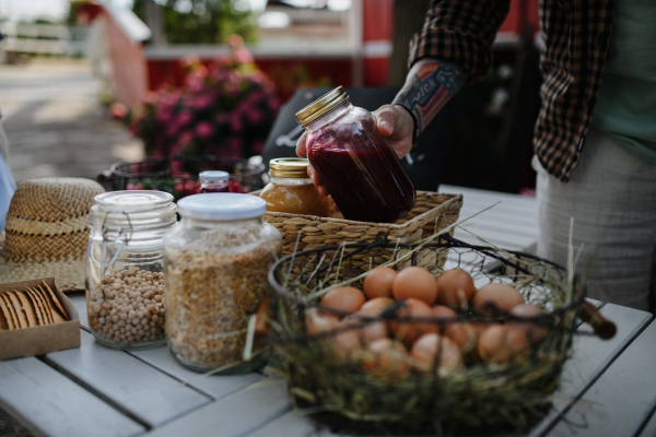 A close up of man buying organic juice outdoors at local farmers market.