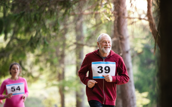 A group of active people running a race competition in nature.