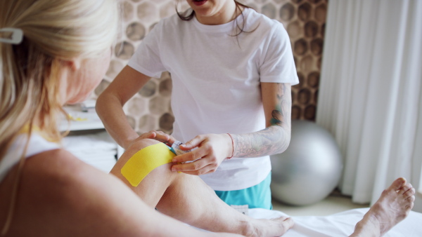 A senior woman in physiotherapy in resort with female therapist.