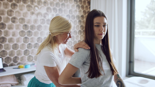 A woman having a physiotherapy with senior female therapist.