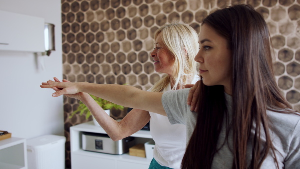 Nurse, caregiver or healthcare worker with senior woman patient, measuring blood glucose indoors.