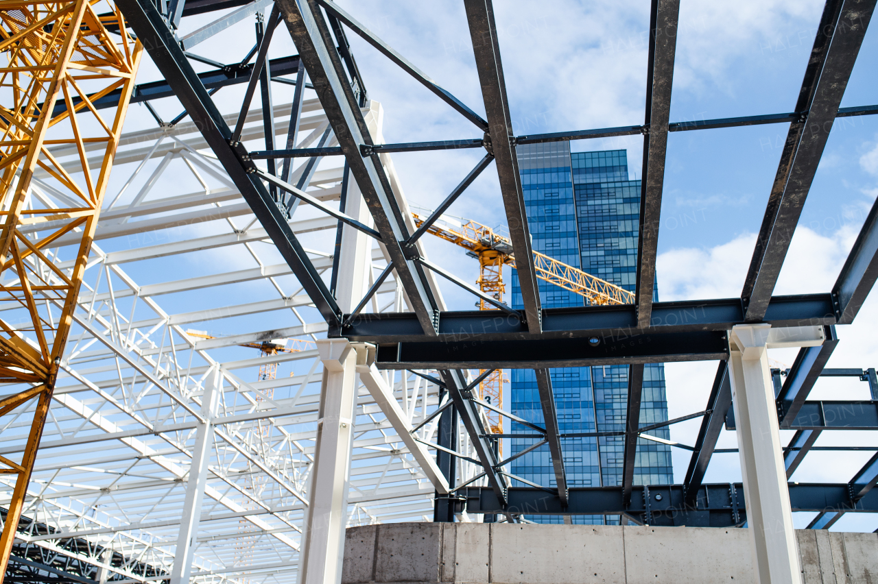 A construction site with steel frame structure and crane.