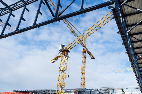 A construction site with steel frame structure and crane.