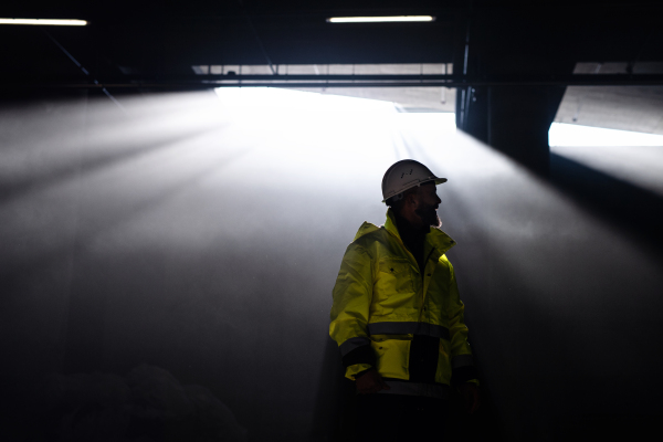 Unrecognizable man engineer standing on construction site. Copy space.