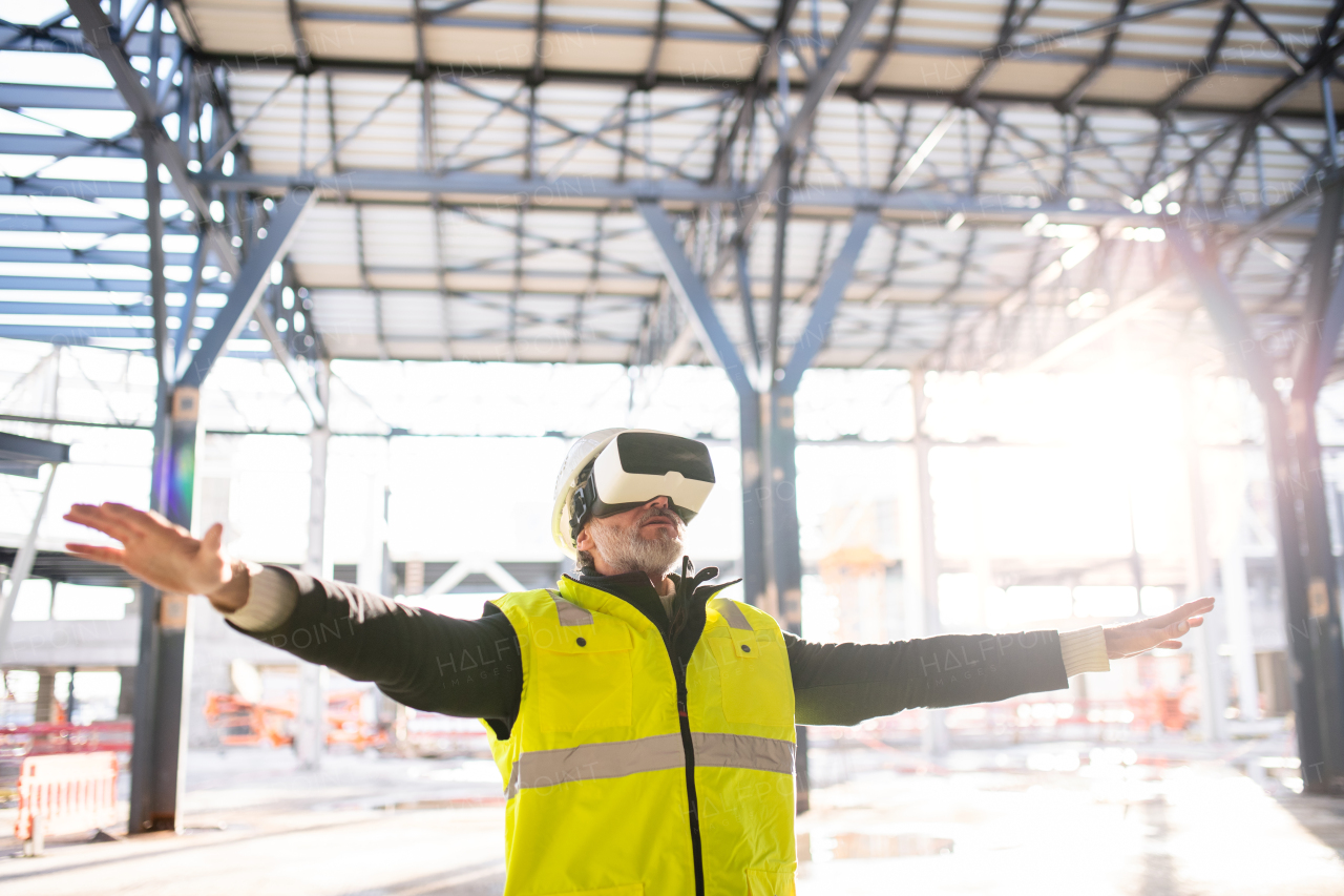 Man engineer using VR goggles outdoors on construction site.