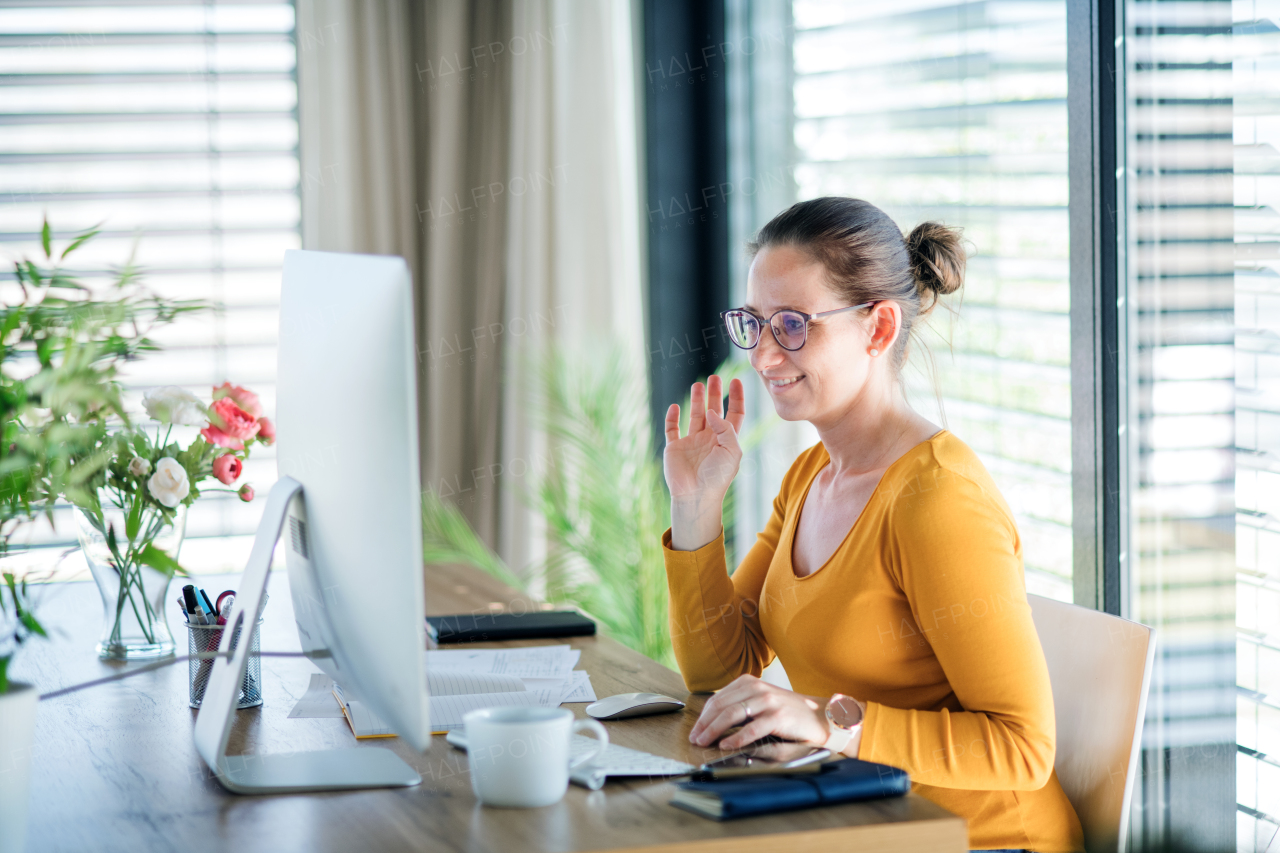 Woman with coffee working indoors at home office, Corona virus and quarantine concept.