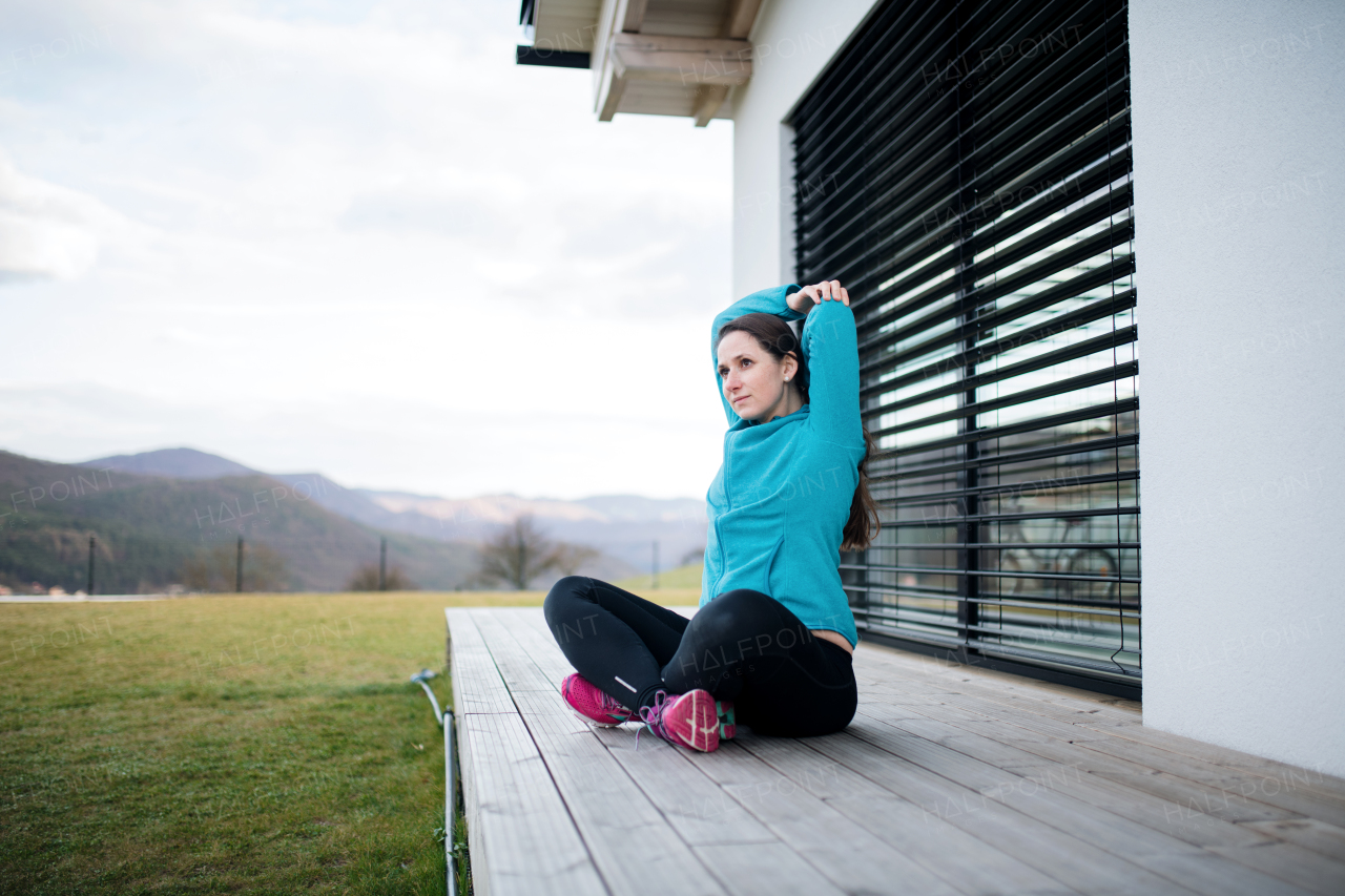 Woman with face masks doing exercise outdoors at home, Corona virus and quarantine concept.