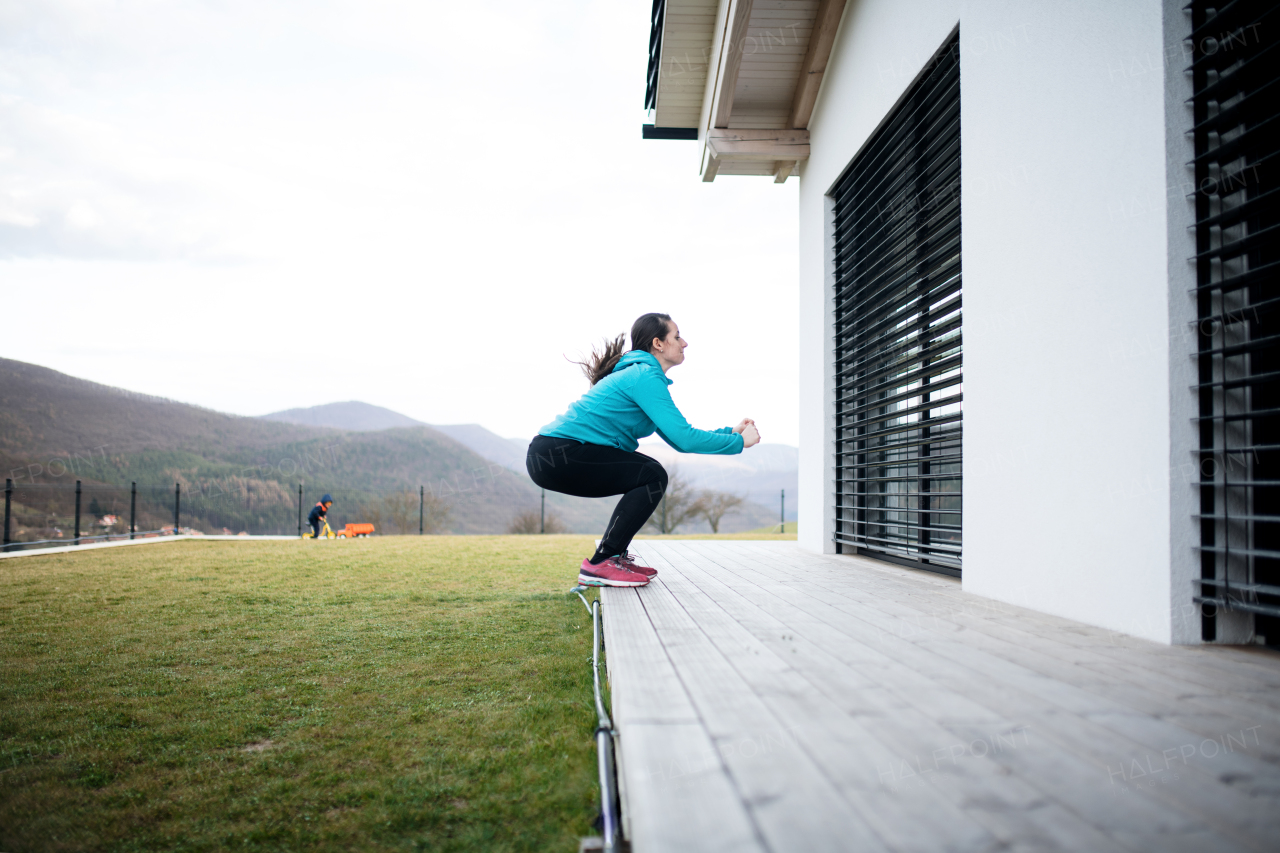 Woman with face masks doing exercise outdoors at home, Corona virus and quarantine concept.