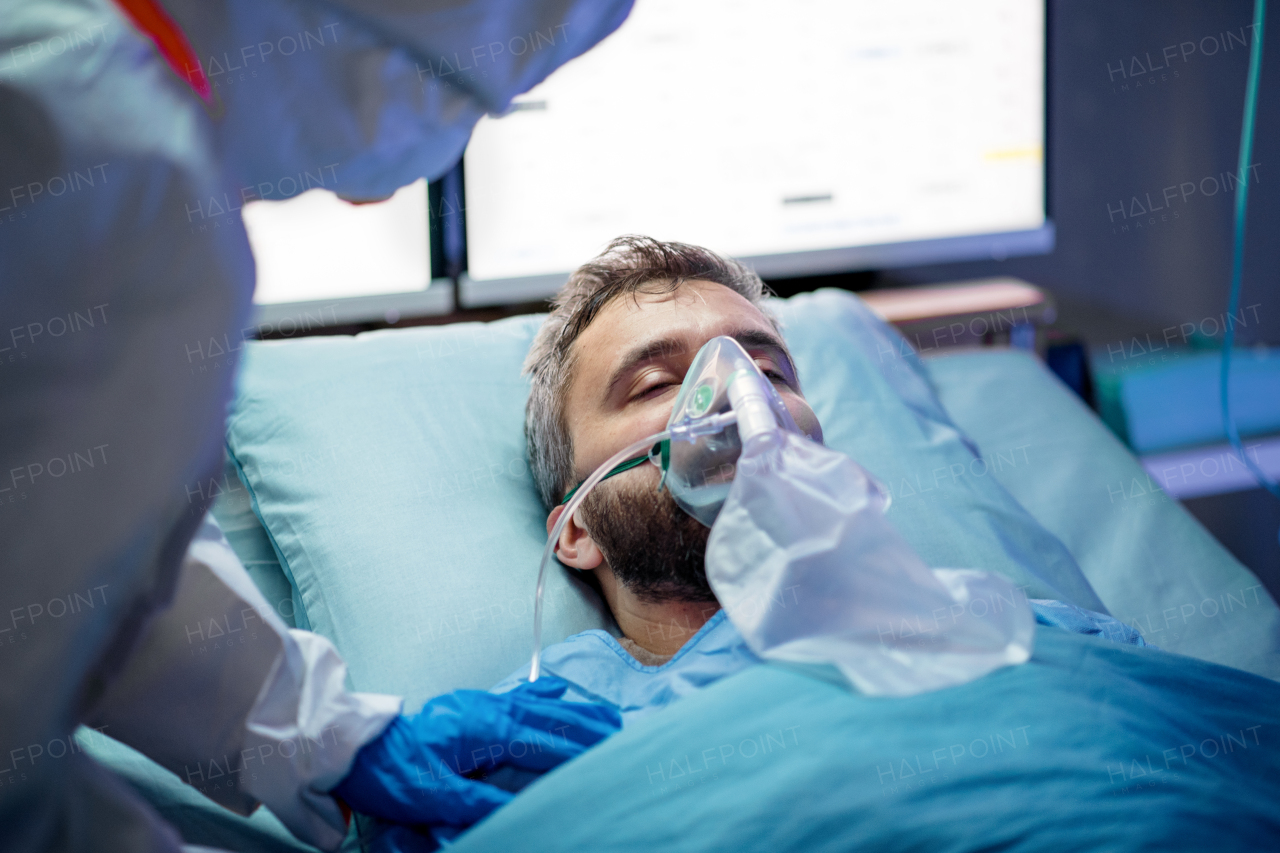 An infected patient in quarantine lying in bed in hospital, coronavirus concept.