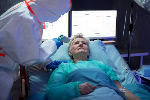 An infected patient in quarantine lying in bed in hospital, coronavirus concept.