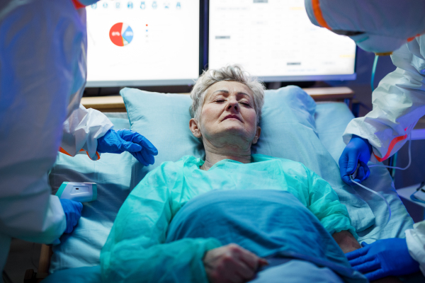 An infected patient in quarantine lying in bed in hospital, coronavirus concept.