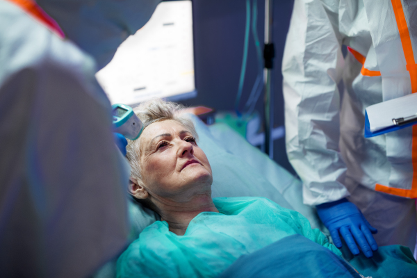 An infected patient in quarantine lying in bed in hospital, coronavirus concept.