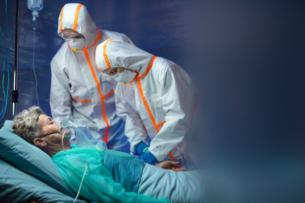 An infected patient in quarantine lying in bed in hospital, coronavirus concept.