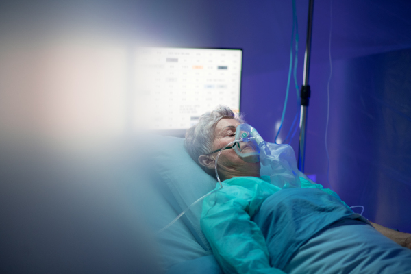 An infected patient in quarantine lying in bed in hospital, coronavirus concept.