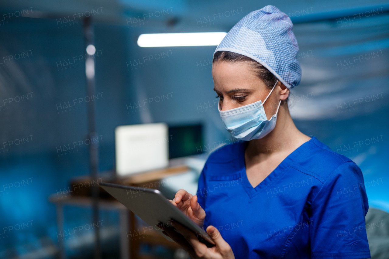 Woman doctor holding tablet in hospital, coronavirus concept.