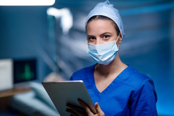 Woman doctor holding tablet in hospital, coronavirus concept.