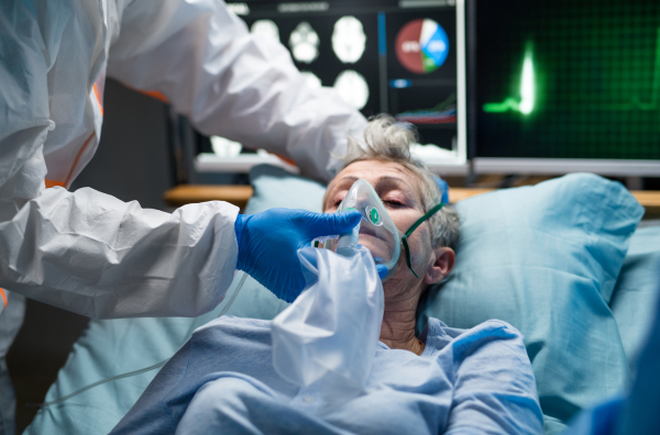 An infected patient in quarantine lying in bed in hospital, coronavirus concept.