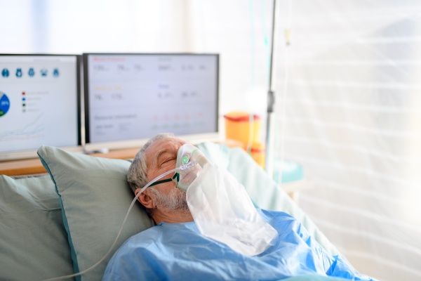 An infected patient in quarantine lying in bed in hospital, coronavirus concept.