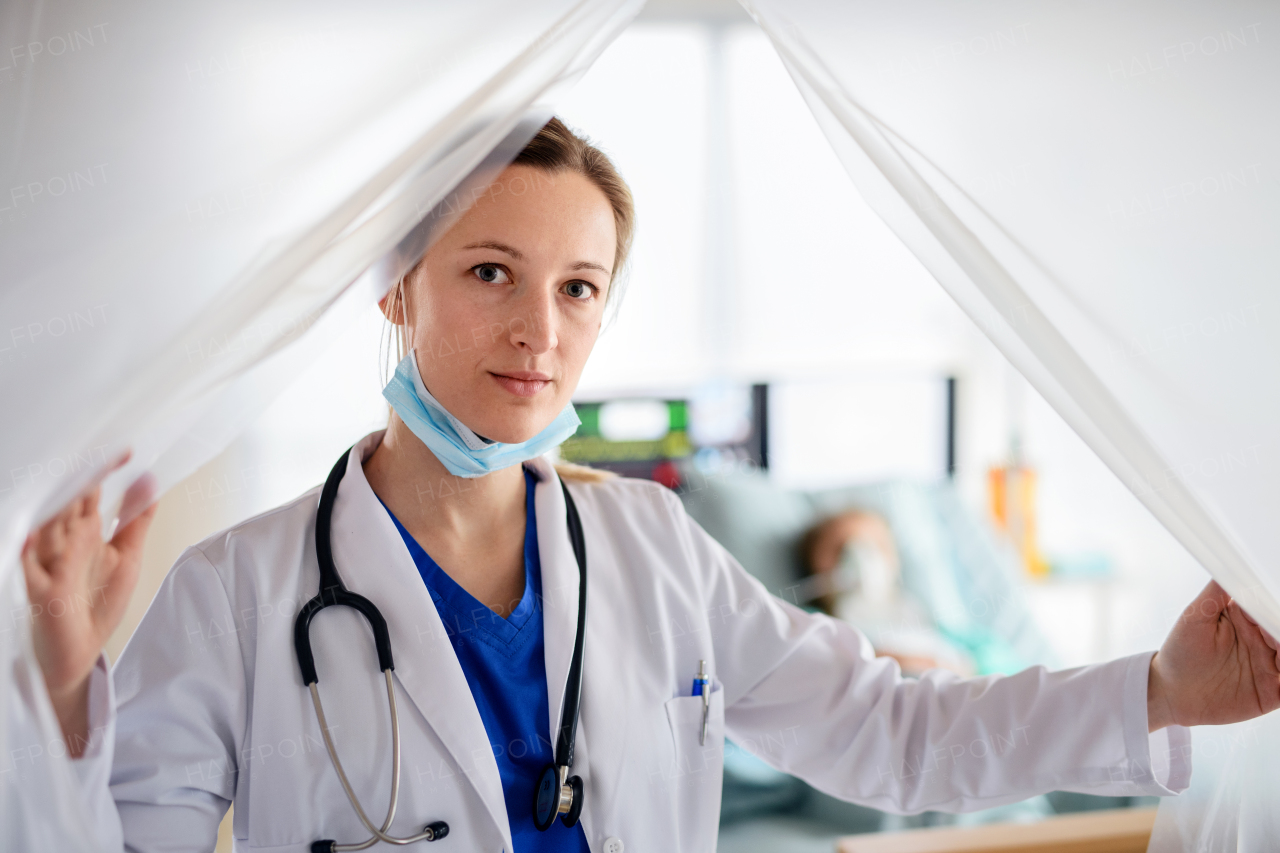 Portrait of doctor in quarantine in hospital, looking at camera. Coronavirus concept.