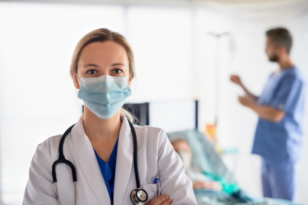 Portrait of doctor in quarantine in hospital, looking at camera. Coronavirus concept.