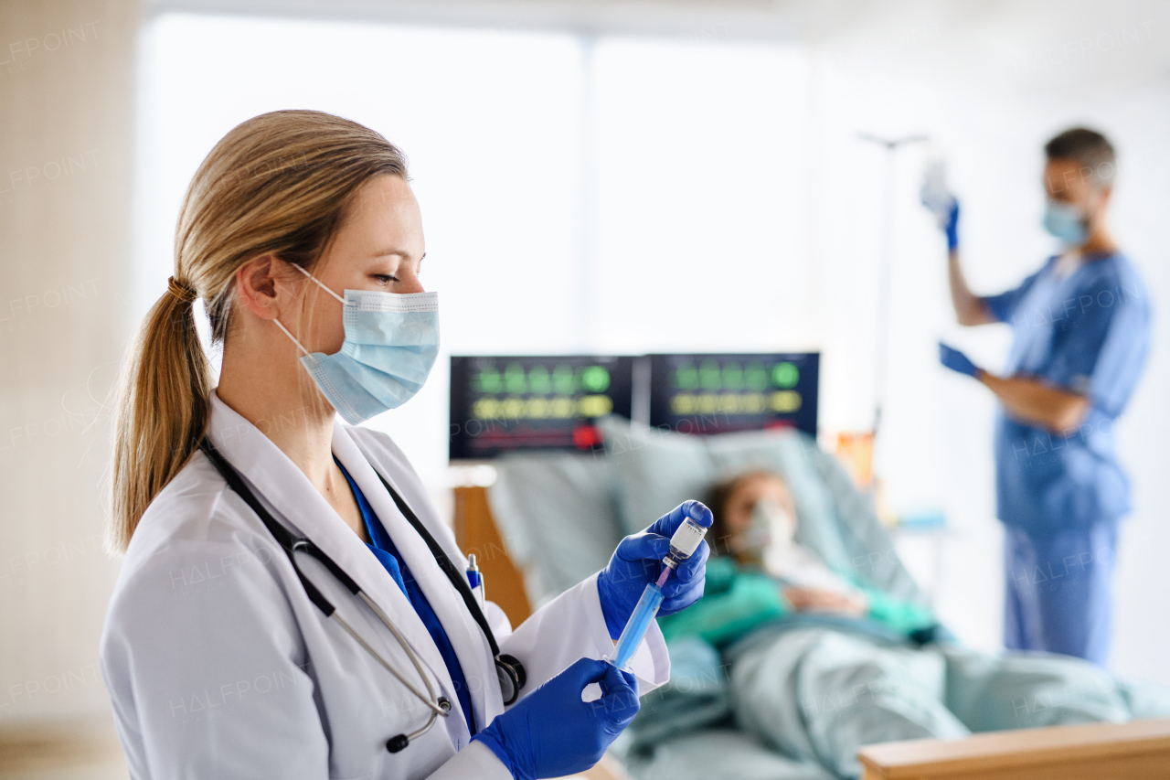 Portrait of doctor with syringe in quarantine in hospital, coronavirus concept.