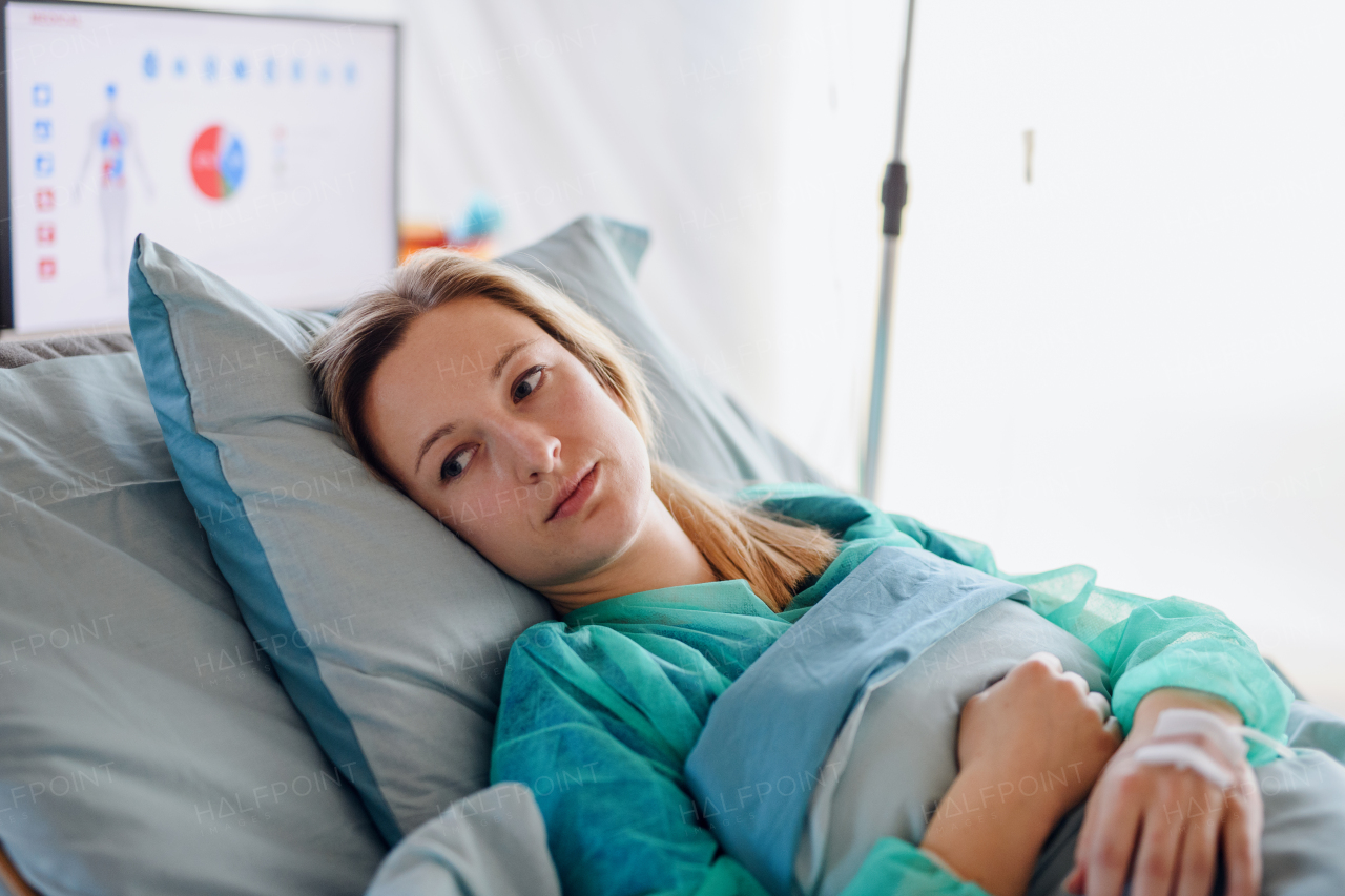 Young infected patient in quarantine lying in bed in hospital, coronavirus concept.