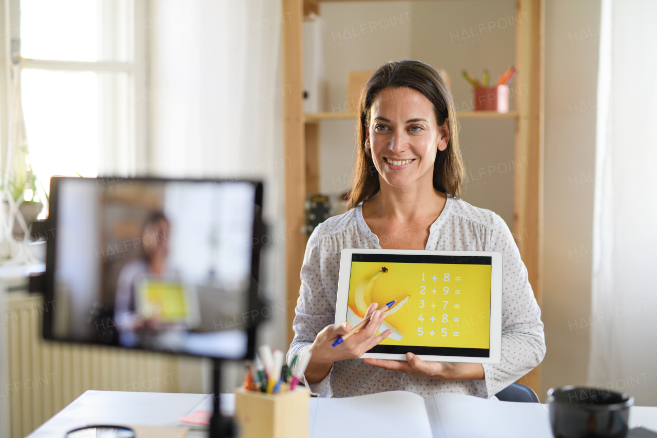 Portrait of woman teacher teaching online, coronavirus and online distance learning concept.