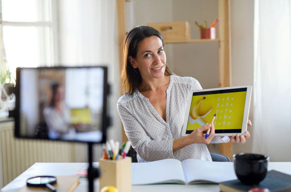 Portrait of woman teacher teaching online, coronavirus and online distance learning concept.