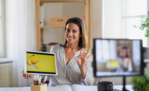 Portrait of woman teacher teaching online, coronavirus and online distance learning concept.