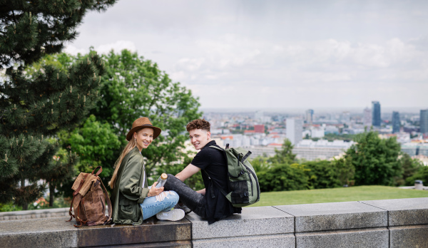 Portrait of young couple travelers with map in city on holiday looking at camera.