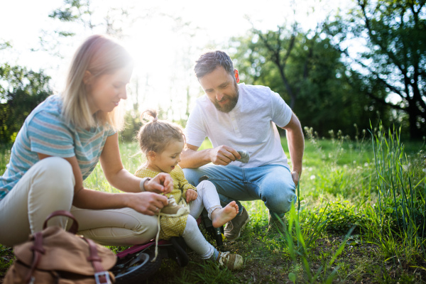 Family with small daughter resting on cycling trip, taking a break.