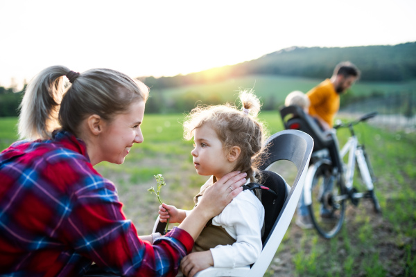 Family with two small children on cycling trip in nature, having fun.