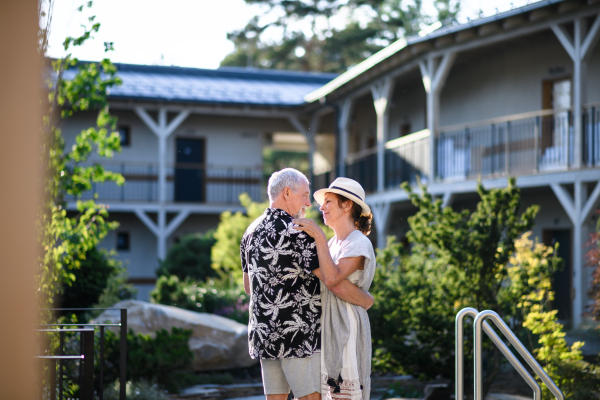 Senior couple dancing outdoors on holiday, having fun. Back to normal concept.