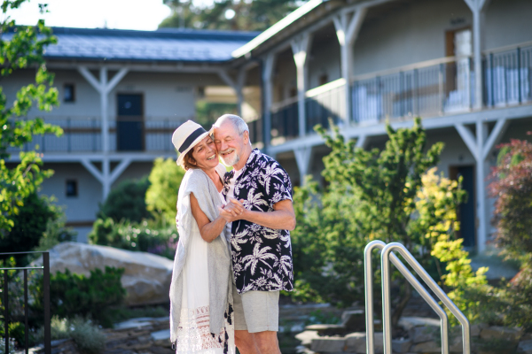 Senior couple dancing outdoors on holiday, having fun. Back to normal concept.