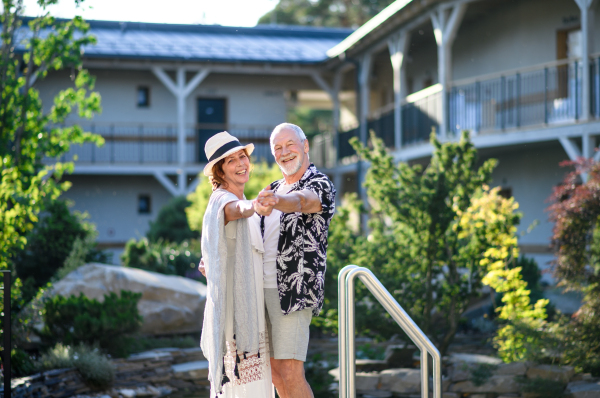 Senior couple dancing outdoors on holiday, having fun. Back to normal concept.