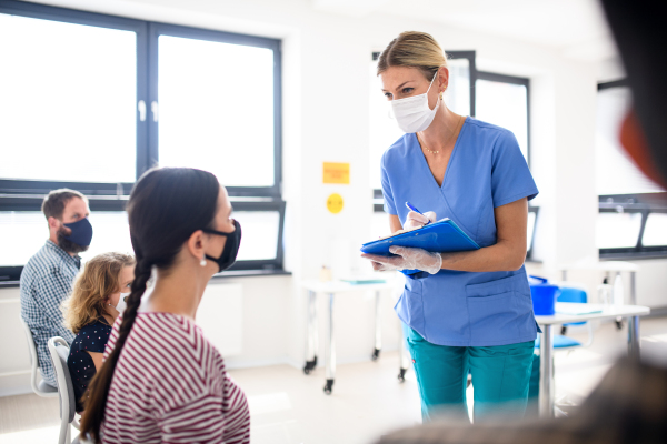 Portrait of nurse and patients with face masks, coronavirus, covid-19 and vaccination concept, signing.