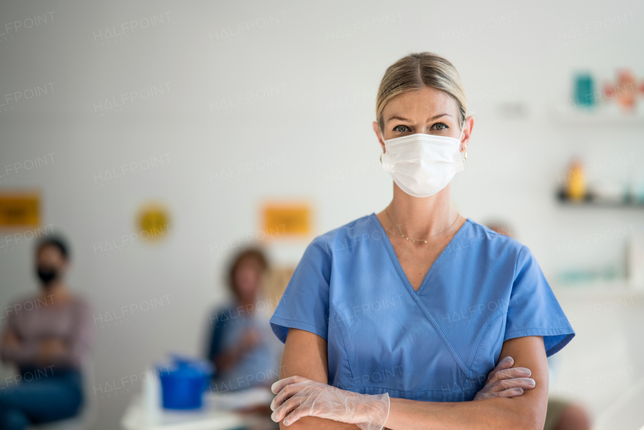 Portrait of woman doctor with face mask looking at camera, coronavirus, covid-19 and vaccination concept.