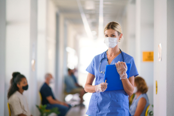 Portrait of nurse and patients with face masks, coronavirus, covid-19 and vaccination concept, in waiting room.