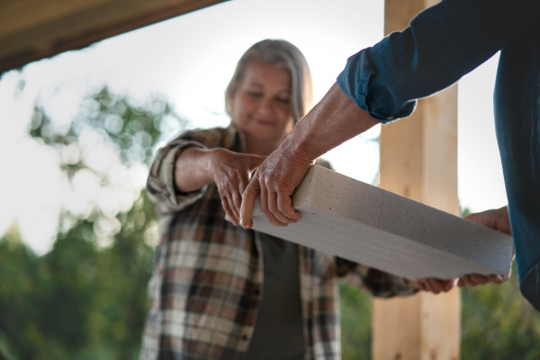 A mature man working on construction site of their new house.