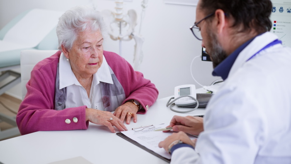 A close-up of senior woman on consultation with doctor in his office.