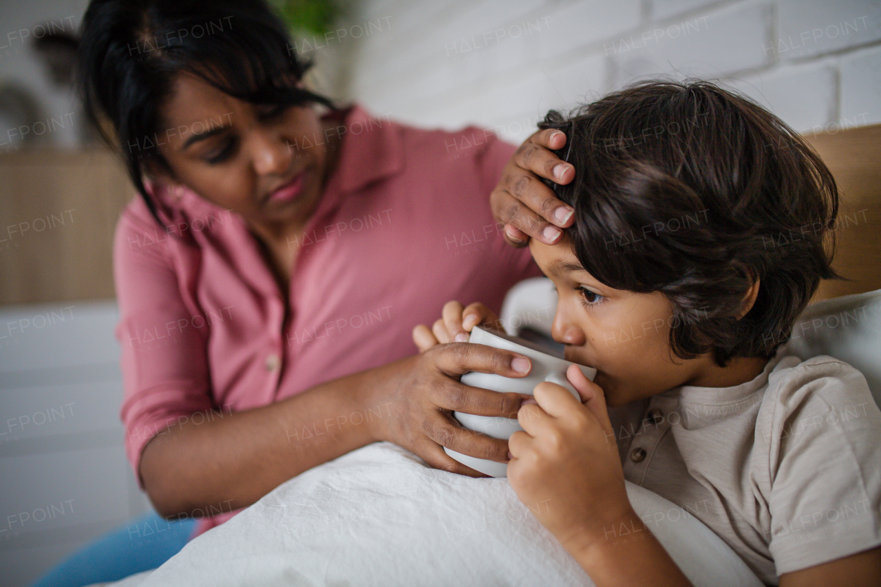 A mother taking care of her ill son at home.