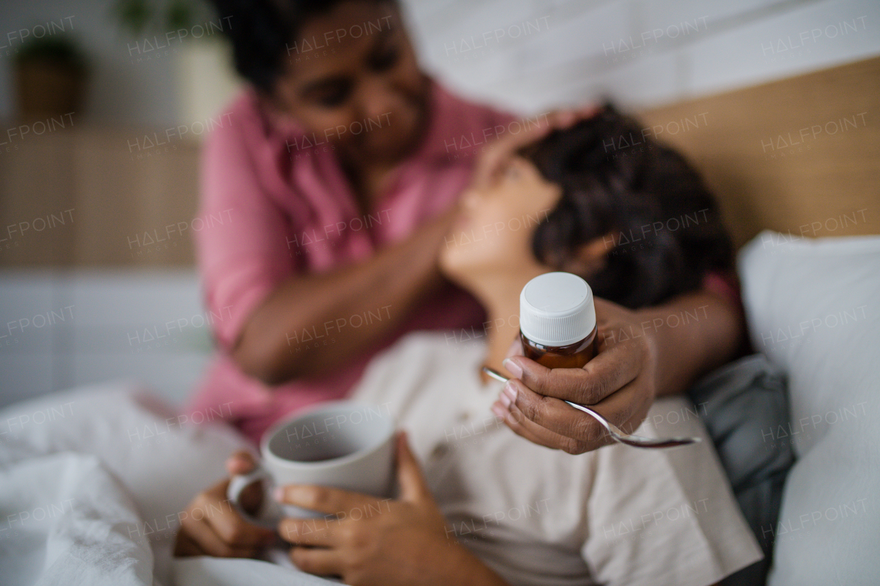 A mother taking care of her sick son at home.