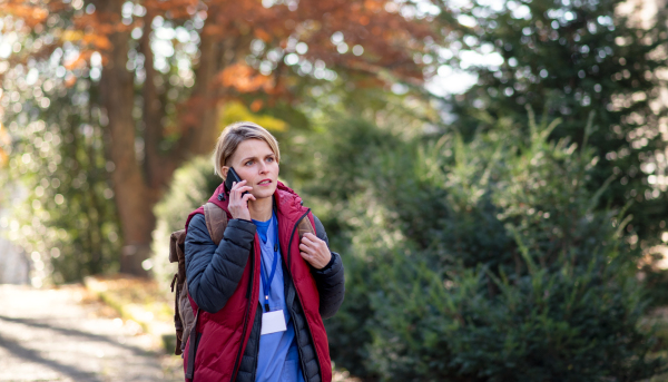 Portrait of woman caregiver, nurse or healthcare worker outdoors on the way to work, coronavirus concept.