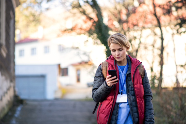 Portrait of woman caregiver, nurse or healthcare worker outdoors on the way to work, coronavirus concept.