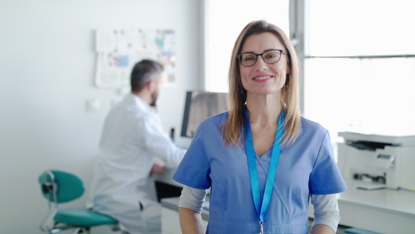 A front view portrait of dental assistant and dentist in modern dental surgery.